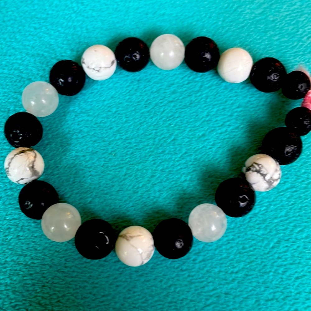 Black and white alternating bead bracelet made by me with stretchy cord